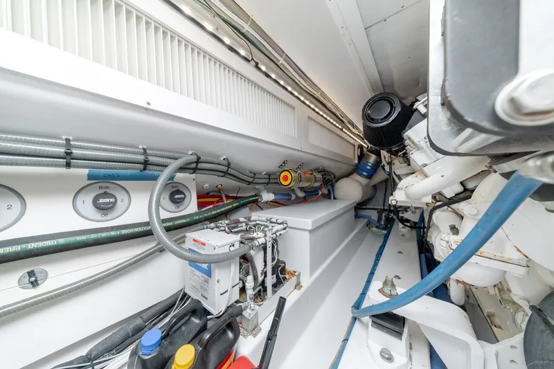 Slide: The Image of Engine room of a 2010 Jamie Chadwick 61' Convertible yacht, showcasing mechanical components. - 47