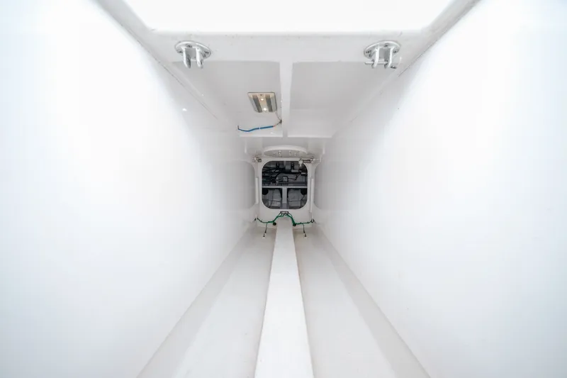 Slide: The Image of Interior view of a 2010 Jamie Chadwick 61' Convertible yacht, showcasing a sleek, white compartment. - 52