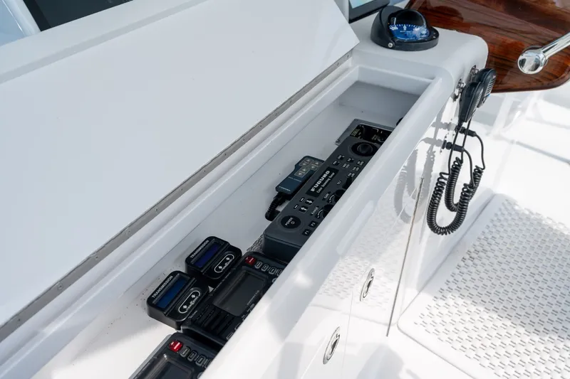Slide: The Image of Control panel of a 2010 Jamie Chadwick 61' Convertible yacht with communication devices. - 63