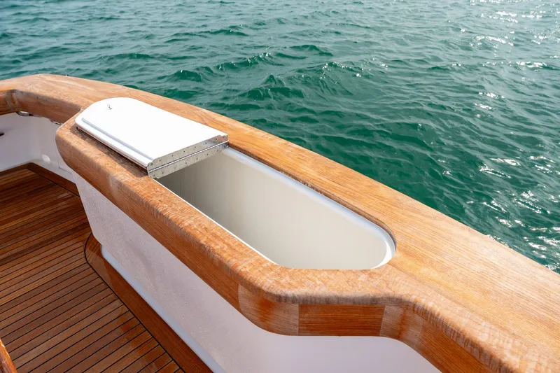 Slide: The Image of Wooden deck detail of a 2010 Jamie Chadwick 61' Convertible yacht on the water. - 31