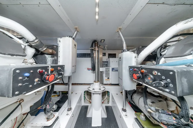 Slide: The Image of Engine room of a 2010 Jamie Chadwick 61' Convertible yacht, featuring control panels and machinery. - 36
