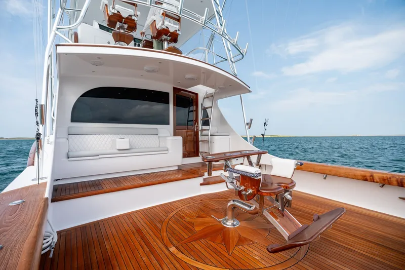 Slide: The Image of Luxurious 2010 Jamie Chadwick 61' Convertible yacht with elegant wooden deck and seating. - 21