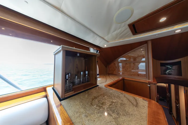 Slide: The Image of Luxurious interior of a 2010 Jamie Chadwick 61' Convertible yacht with elegant wood finishes. - 79