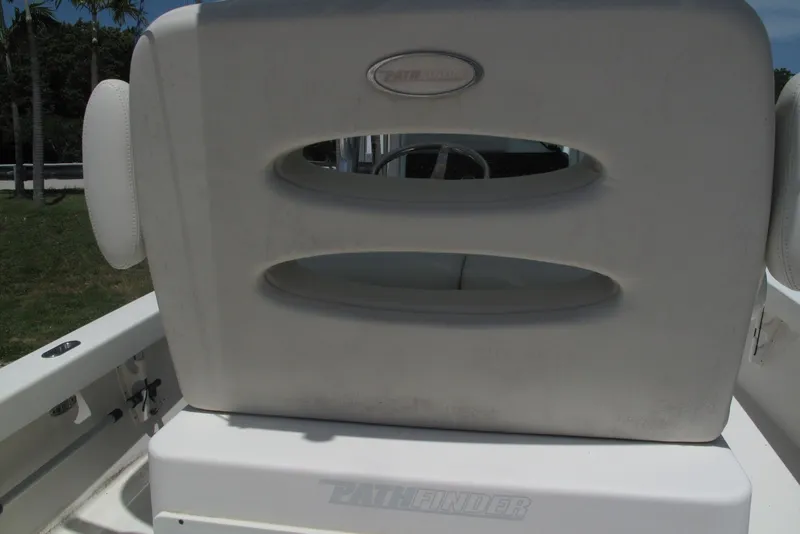Slide: The Image of 2018 Pathfinder 2500 Hybrid boat seat with logo, white upholstery, outdoor setting. - 27