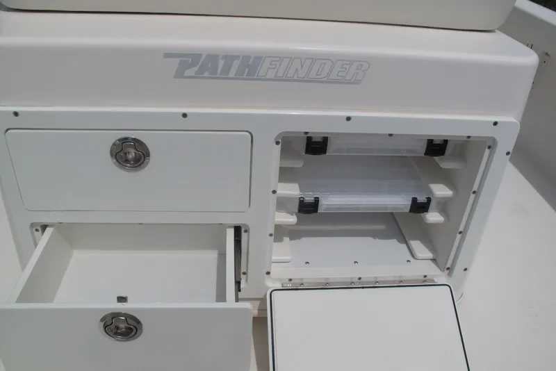 Slide: The Image of Pathfinder 2500 Hybrid 2018 boat storage compartments with drawers and tackle boxes. - 16