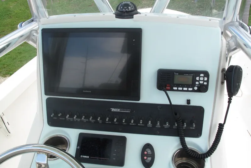 Slide: The Image of 2018 Pathfinder 2500 Hybrid boat dashboard with Garmin display and radio controls. - 15