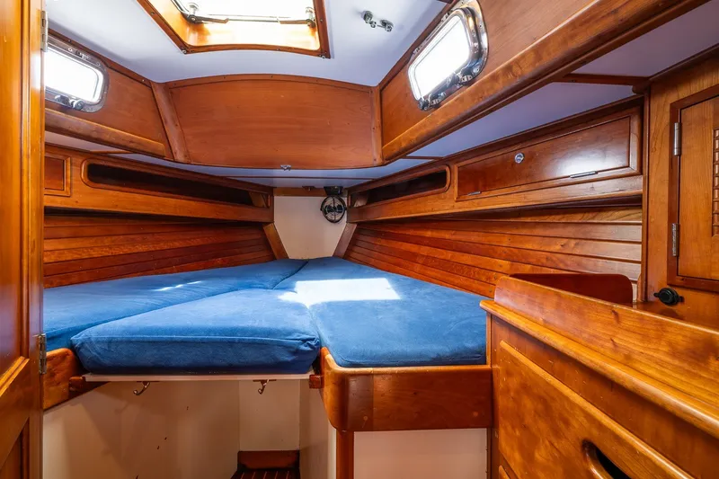 Slide: The Image of Cozy wooden cabin interior of 1990 Able 42 sailboat with blue bedding. - 36