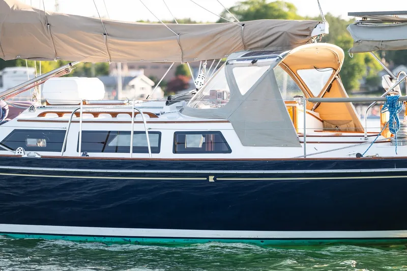 Slide: The Image of Sailboat on water, Able 42 model, 1990, with beige canopy and sleek design. - 7