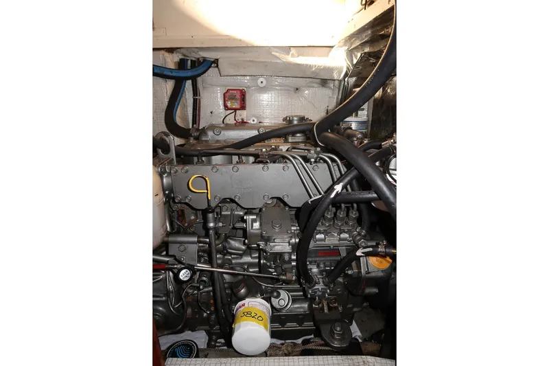 Slide: The Image of Engine compartment of a 1990 Able 42 boat, showcasing mechanical components and hoses. - 41