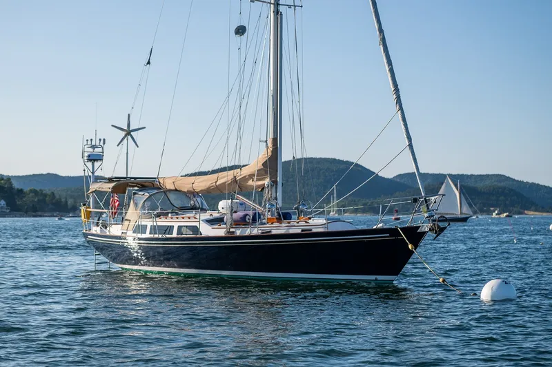 The Image of Sailboat "Able 42" from 1990 anchored in scenic bay with hills in background. - 1