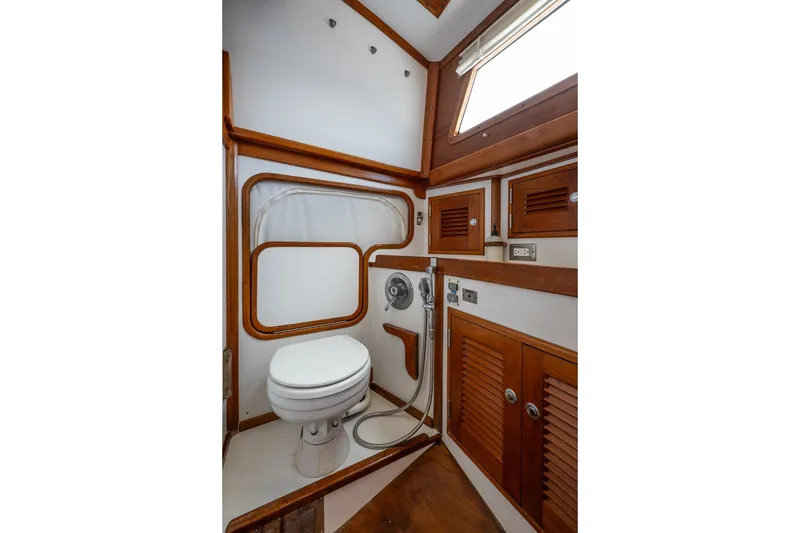 Slide: The Image of Vintage 1990 Able 42 yacht bathroom with wooden accents and compact design. - 31