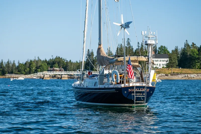 Slide: The Image of Sailboat "Nickleby II" on water, Able 42 model, 1990, with American flag, scenic background. - 47