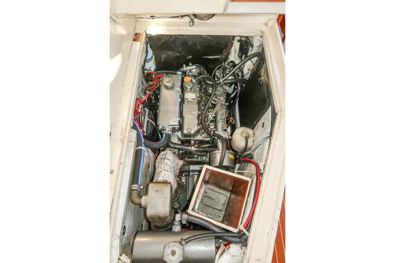 Slide: The Image of Engine compartment of a 1990 Able 42 boat, showcasing mechanical components and wiring. - 40