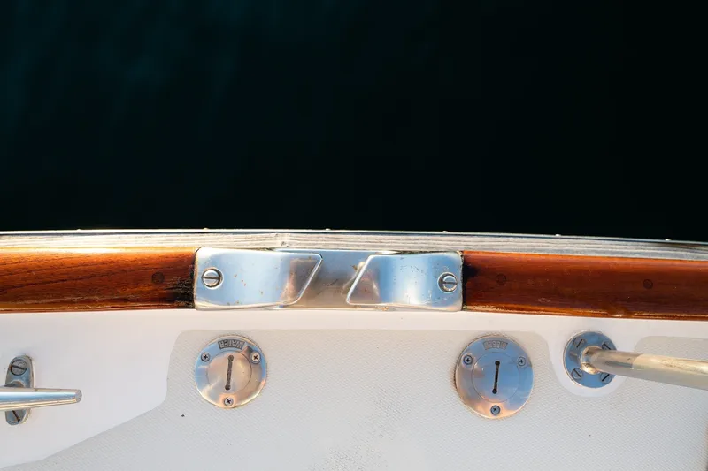 Slide: The Image of Deck fittings on a 1990 Able 42 boat, featuring polished metal and wood accents. - 24