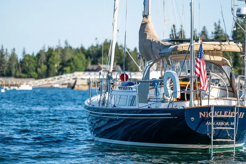 Slide: The Image of Sailboat "Nickleby II" on water, Able 42 model, 1990, with American flag, scenic background. - 6
