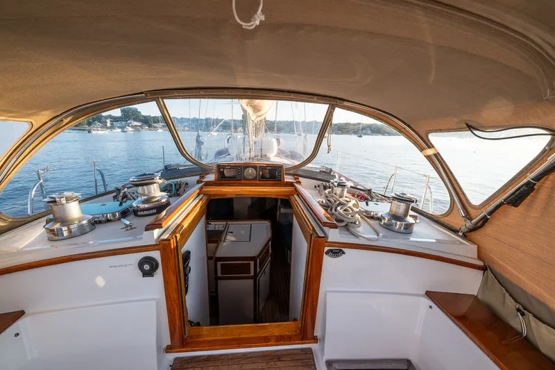 Slide: The Image of Cockpit view of a 1990 Able 42 sailboat on calm waters. - 21