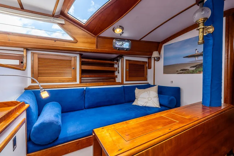 Slide: The Image of Cozy interior of 1990 Able 42 yacht with blue seating and wooden accents. - 34