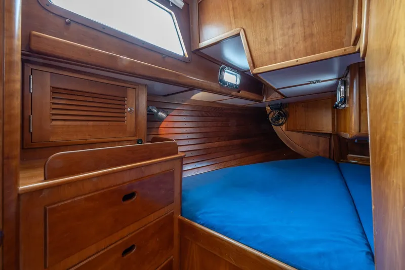 Slide: The Image of Cozy wooden cabin interior of 1990 Able 42 sailboat with blue bedding. - 29