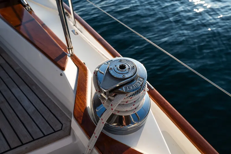 Slide: The Image of Sailboat deck with winch and rope, Able 42 model, 1990, on calm blue water. - 23
