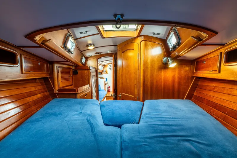 Slide: The Image of Cozy cabin interior of 1990 Able 42 sailboat with wooden finish and blue cushions. - 37
