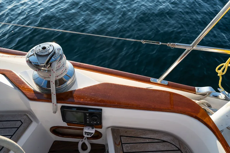 Slide: The Image of Sailboat deck with winch and rope, Able 42 model, 1990, on calm blue water. - 22