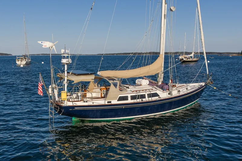 Slide: The Image of Sailboat on calm water, 1990 Able 42 model, with American flag and clear blue sky. - 2