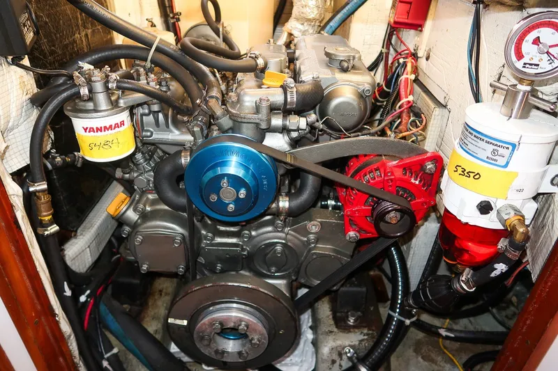 Slide: The Image of Engine compartment of a 1990 Able 42, featuring Yanmar components and fuel filters. - 42