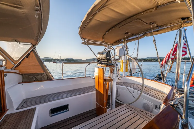 Slide: The Image of Cockpit of a 1990 Able 42 sailboat with scenic water view and American flag. - 17