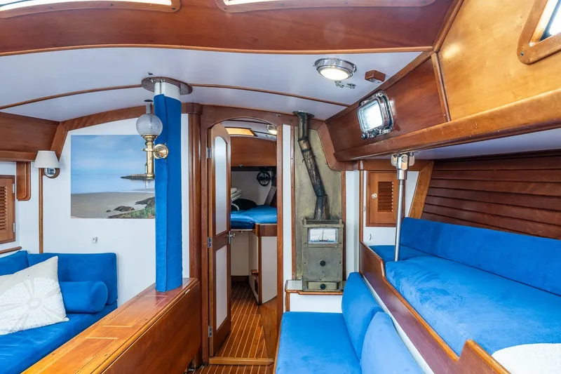 Slide: The Image of Cozy interior of a 1990 Able 42 sailboat with blue seating and wooden accents. - 27
