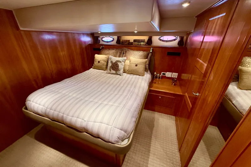 Slide: The Image of Luxurious bedroom interior of 2007 Navigator 44 Classic yacht with wood paneling and cozy bedding. - 29