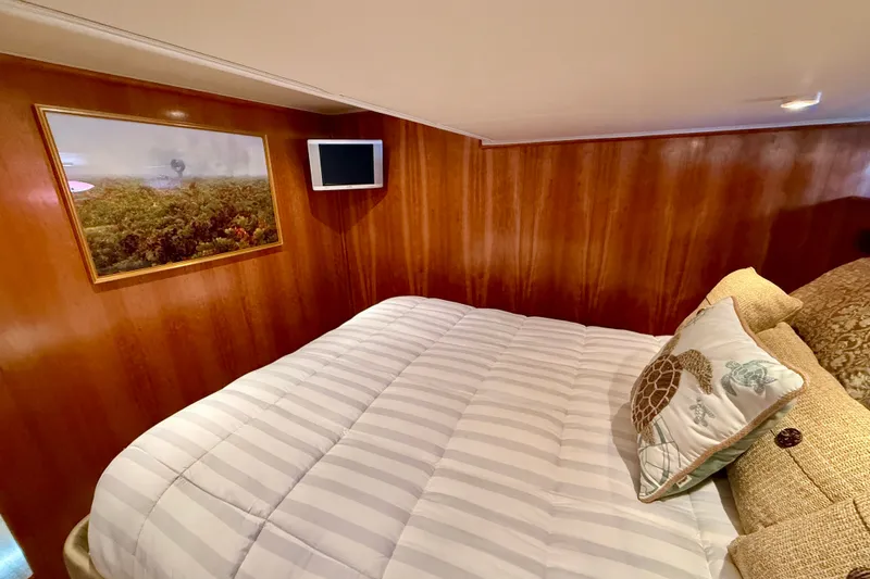 Slide: The Image of Cozy bedroom in 2007 Navigator 44 Classic yacht with wood paneling and decorative pillows. - 31