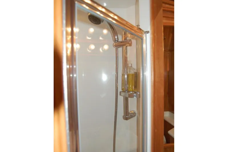 Slide: The Image of Shower area in 2007 Navigator 44 Classic yacht with glass door and chrome fixtures. - 37