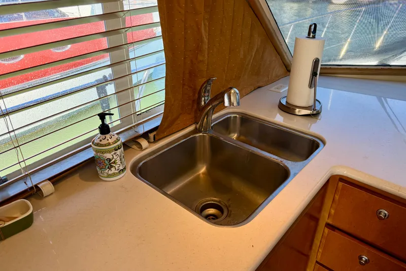 Slide: The Image of Kitchen sink area on a 2007 Navigator 44 Classic yacht with countertop and window view. - 24