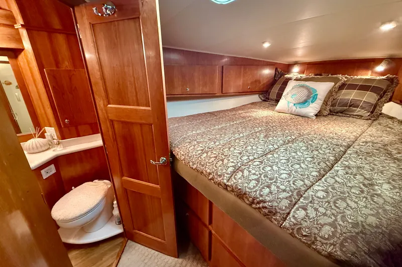 Slide: The Image of Luxurious 2007 Navigator 44 Classic yacht bedroom with elegant wood finish and cozy bedding. - 38