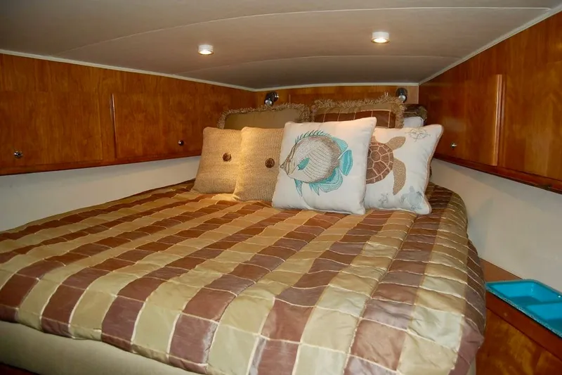 Slide: The Image of Cozy cabin bedroom in 2007 Navigator 44 Classic yacht with decorative pillows and wood paneling. - 31