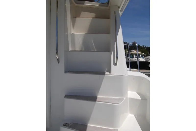 Slide: The Image of Staircase on 2007 Navigator 44 Classic yacht, featuring sleek white design and metal handrails. - 6