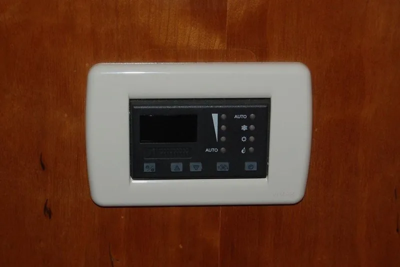 Slide: The Image of Control panel on 2007 Navigator 44 Classic yacht, mounted on wooden surface. - 35