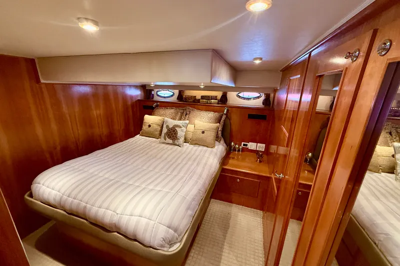 Slide: The Image of Luxurious bedroom interior of 2007 Navigator 44 Classic yacht with wood paneling and cozy bedding. - 30