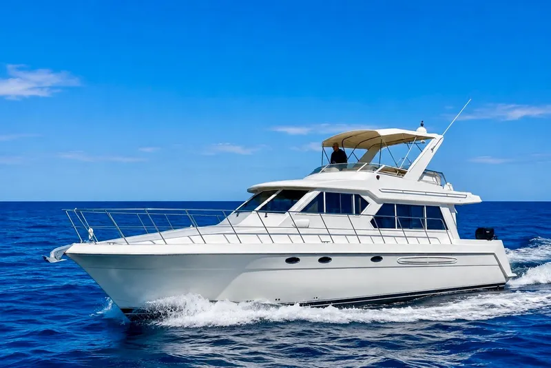 Slide: The Image of 2007 Navigator 44 Classic yacht cruising on open blue sea under clear sky. - 1