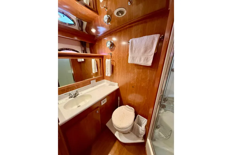Slide: The Image of Luxurious bathroom in 2007 Navigator 44 Classic yacht with wood paneling and modern fixtures. - 34
