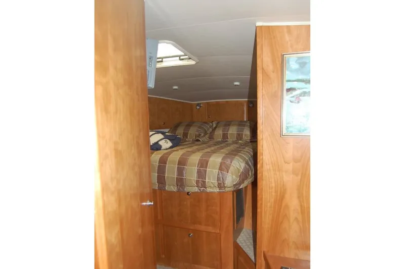 Slide: The Image of Cozy cabin interior of 2007 Navigator 44 Classic yacht with wood paneling and bed. - 32