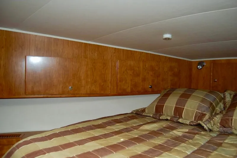 Slide: The Image of Cozy cabin interior of 2007 Navigator 44 Classic yacht with wood paneling and striped bedding. - 34