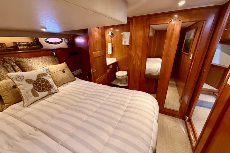 Slide: The Image of Luxurious 2007 Navigator 44 Classic yacht bedroom with cozy bedding and elegant wood finishes. - 33