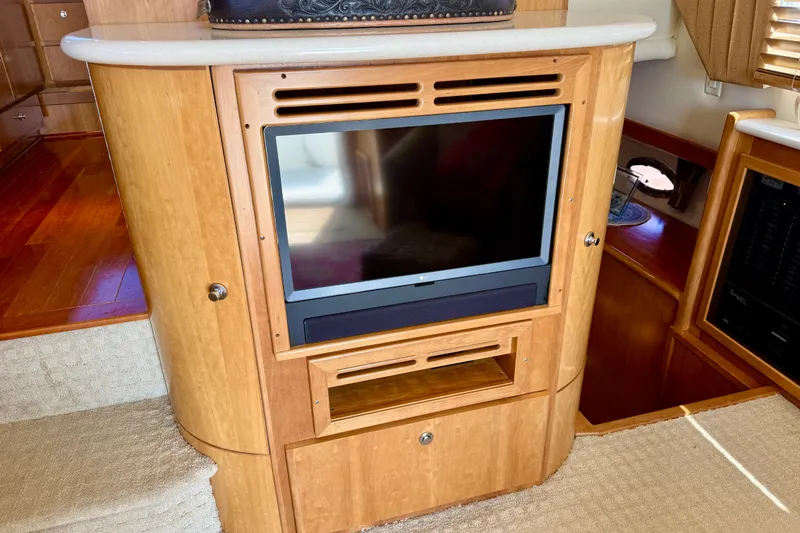 Slide: The Image of Interior of 2007 Navigator 44 Classic yacht with built-in TV and wooden cabinetry. - 13