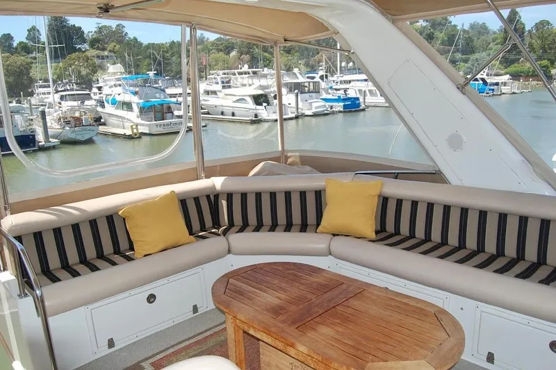 Slide: The Image of Luxurious 2007 Navigator 44 Classic yacht interior with striped seating and marina view. - 39