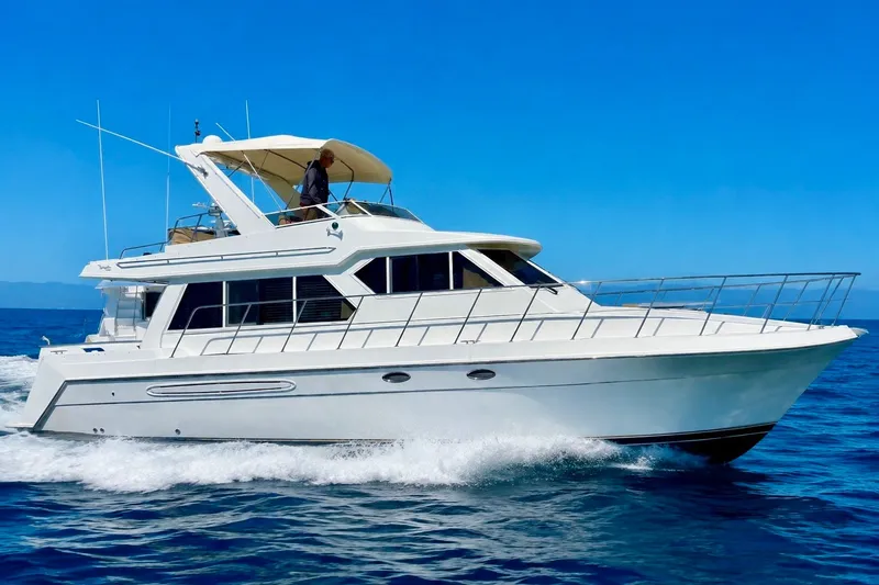Slide: The Image of 2007 Navigator 44 Classic yacht cruising on open water under clear blue skies. - 2