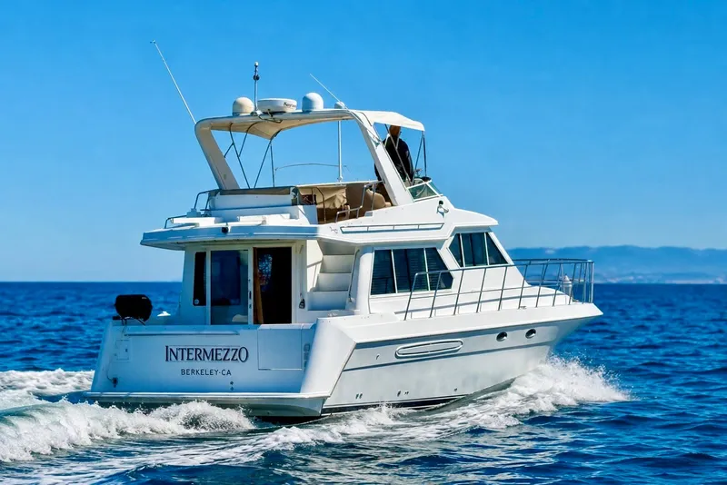 Slide: The Image of 2007 Navigator 44 Classic yacht cruising on open sea under clear blue sky. - 3