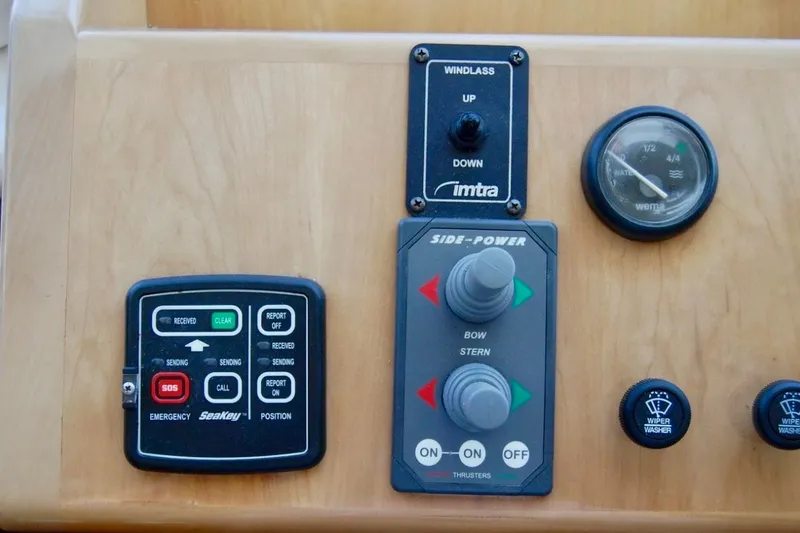 Slide: The Image of Control panel of a 2007 Navigator 44 Classic boat with various switches and gauges. - 16