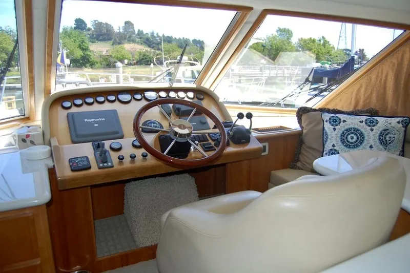 Slide: The Image of 2007 Navigator 44 Classic yacht helm with steering wheel, controls, and plush seating. - 14