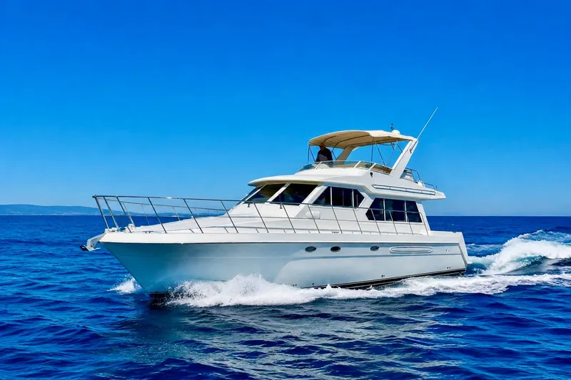 The Image of 2007 Navigator 44 Classic yacht cruising on open blue sea under clear sky. - 0